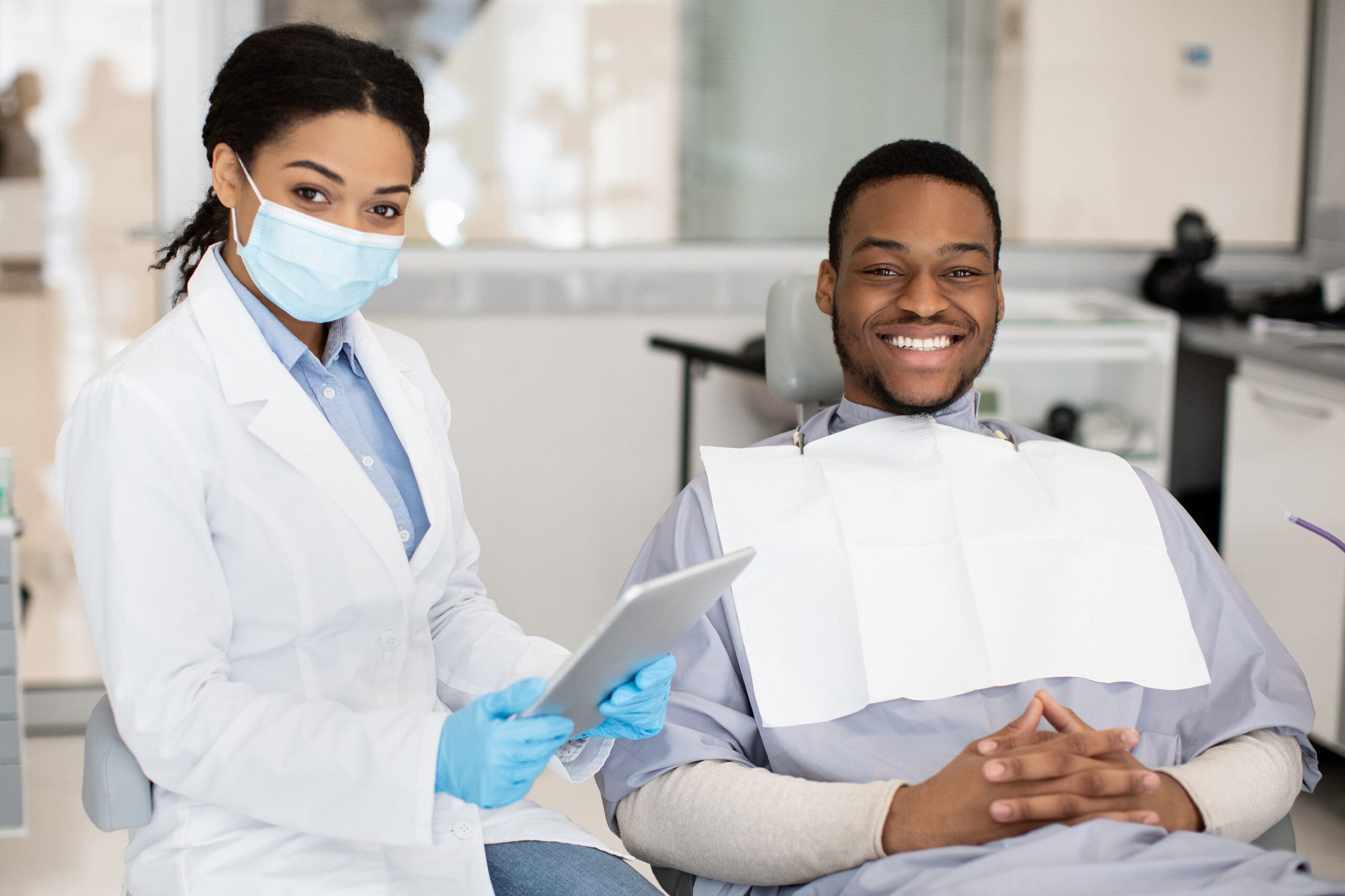 Dental Insurance Concept. Black Dentist Woman And Male Patient P